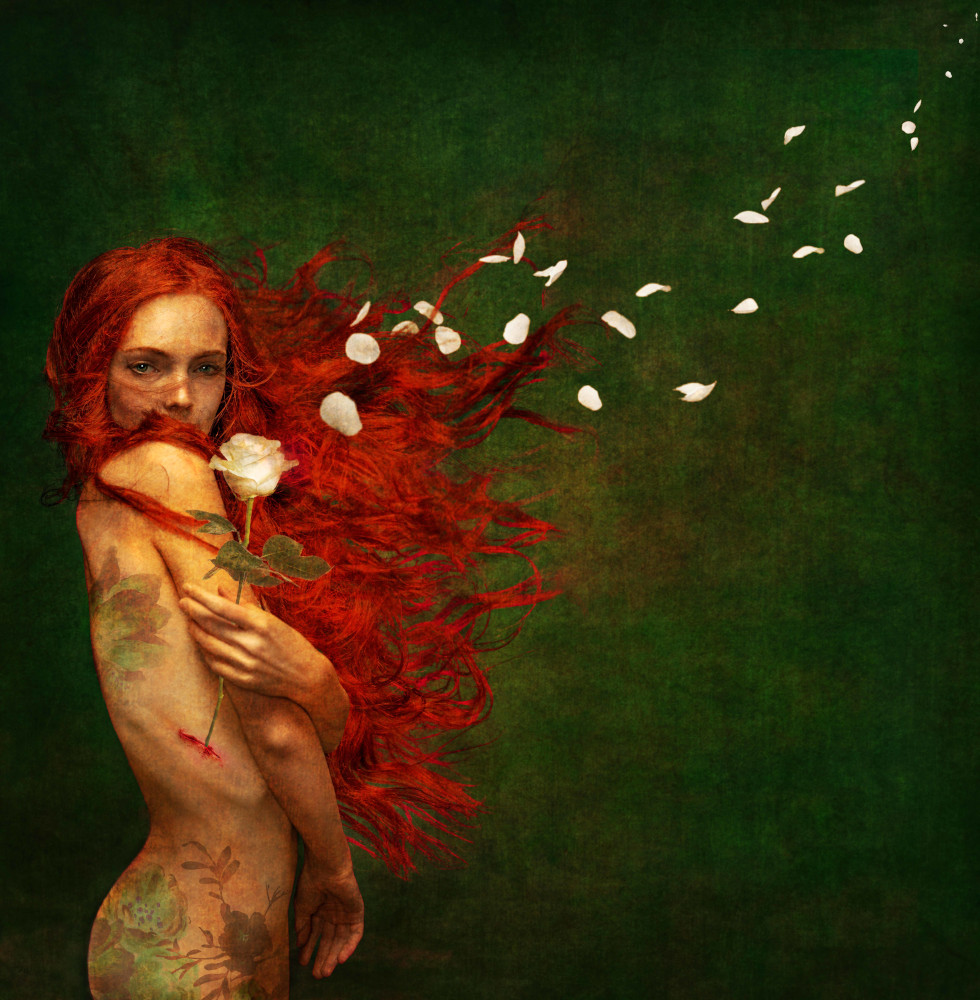 A nude woman with red hair adorned with flowers.